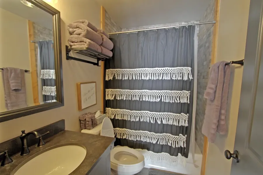 The upper level bathroom has a full size tub/shower combo.