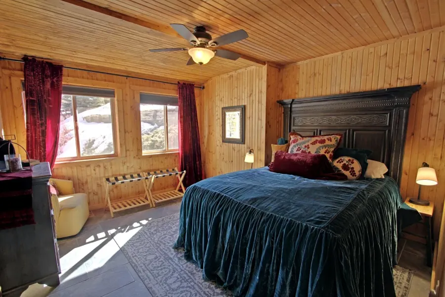 Bedroom 2 on the main level has a queen size bed.